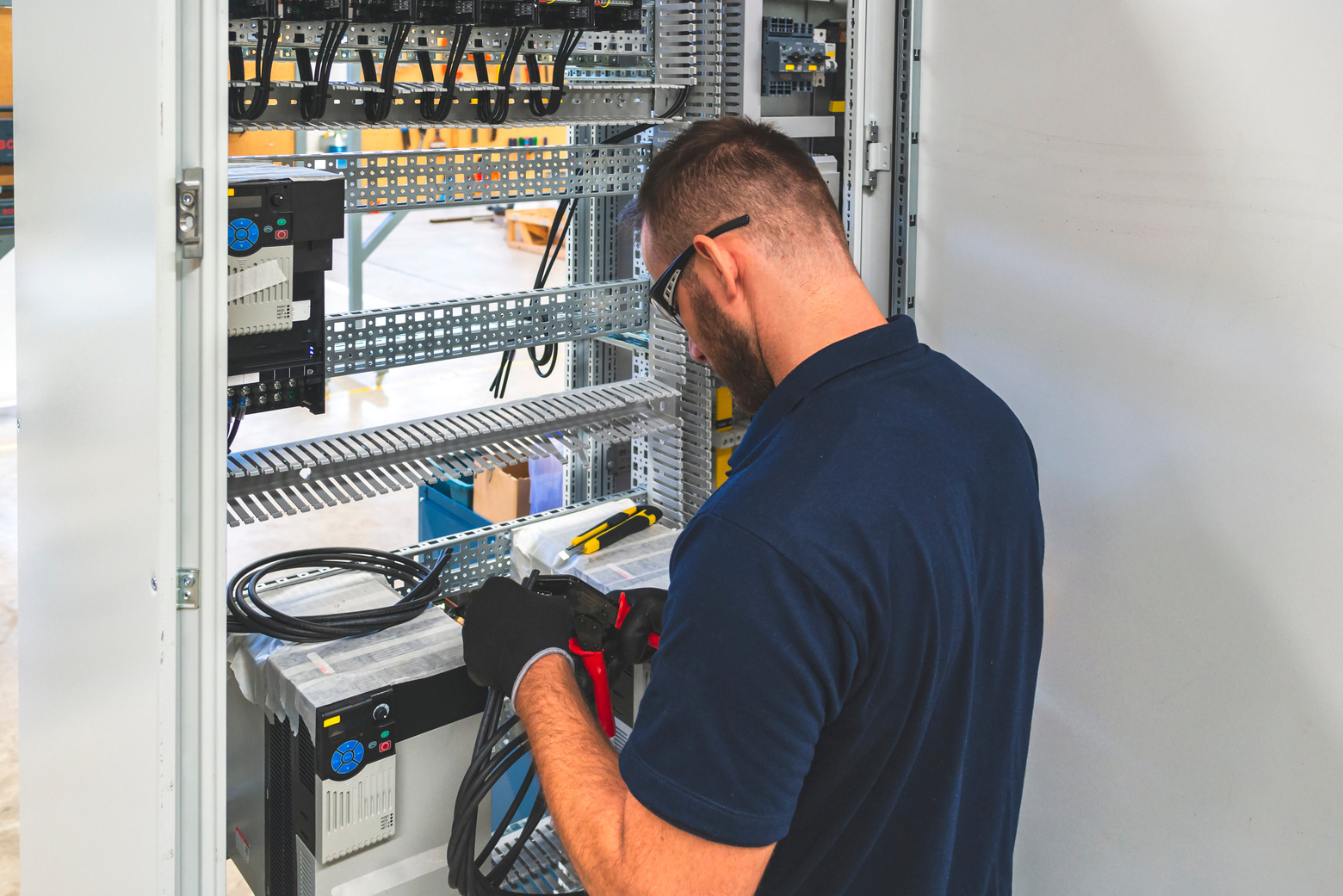 Electrician working at electric panel